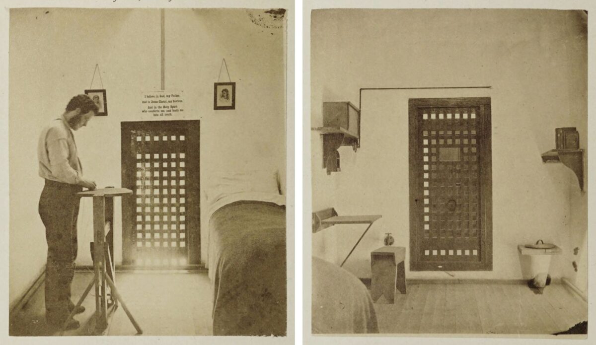 A diptych photograph of the interior of a Philadelphia prison cell, taken in the late 1800s. In the left photo a man stands behind a tall table or lectern across the room from a bed. In the right photo, the other side of the room can be seen, including shelves, a small table and stool, a latrine, and the corner of the bed.